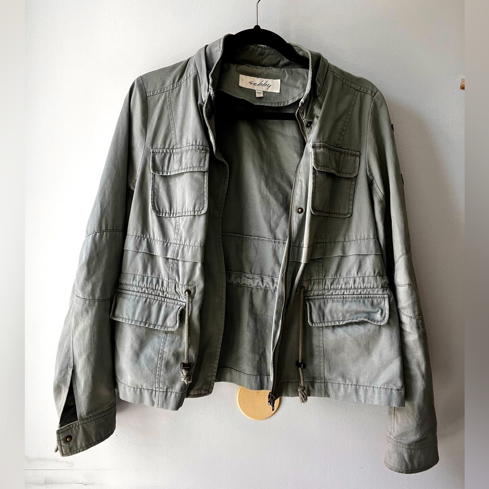 Army green fall jacket with cinch ties around waist